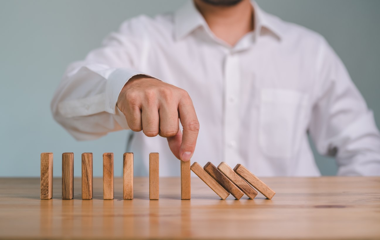 Hand Stopping the domino crisis effect