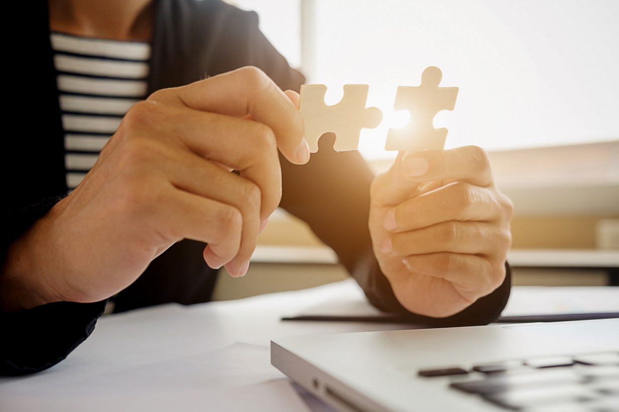 woman hands connecting jigsaw puzzle